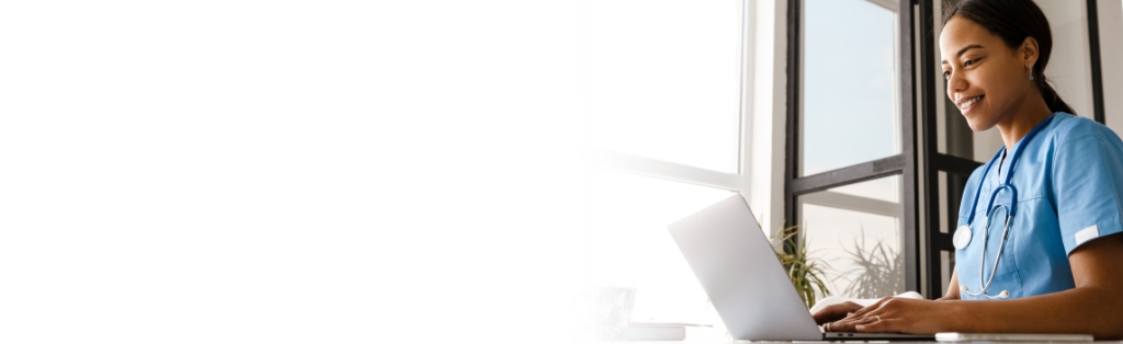 medical professional looking at laptop computer