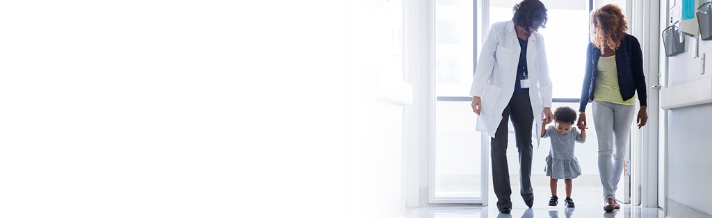 Doctor walking with patient and her mother