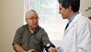 Doctor checking mans blood pressure Doctor checking mans blood pressure