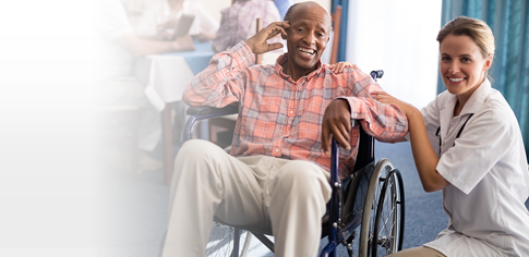 doctor sitting next to patient in wheelchair