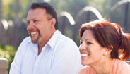 Couple sitting outside smiling