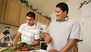 Father and son cutting vegetables