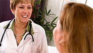 Female doctor and woman smiling