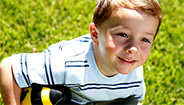 Boy outside on grass