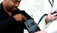 Doctor measuring man's blood pressure