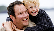 Father and son smiling