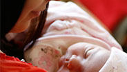 Mother holding sleeping baby Mother holding sleeping baby