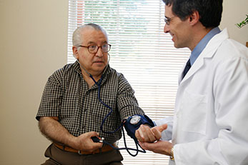 Doctor taking patients blood pressure