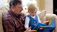 Man reading to little girl
