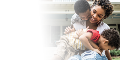 Mother smiling and holding two children